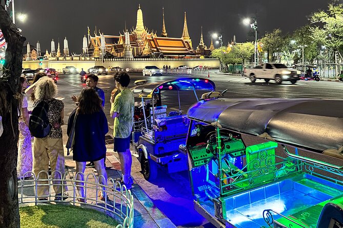 Bangkok Night Tour: Food, Temple & Tuk Tuk - Wat Prayurawongsawat under evening lights