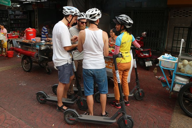 Explore Bangkok by E-Scooter & Try Street Food - Feeding fish near Princess Mother Memorial Park