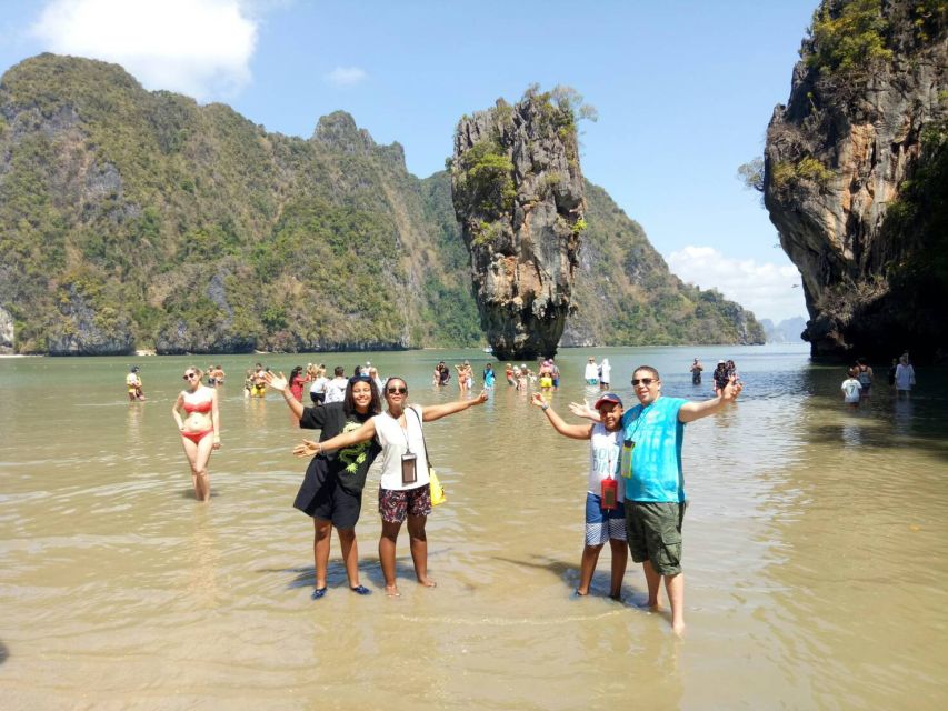 Limestone islands standing in the shallow green water of Phang Nga Bay
