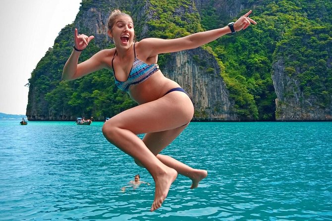 Phi Phi Early Bird & 4 Islands - Day Tour by Speedboat From Krabi - Pileh Bay: cliffs, green water, and a swim from the boat