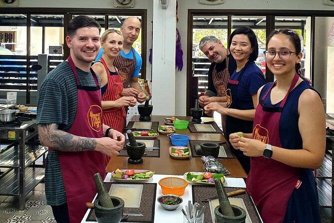 Phuket Thai Cooking Class with Market Tour Option - Grinding curry paste with a mortar and pestle